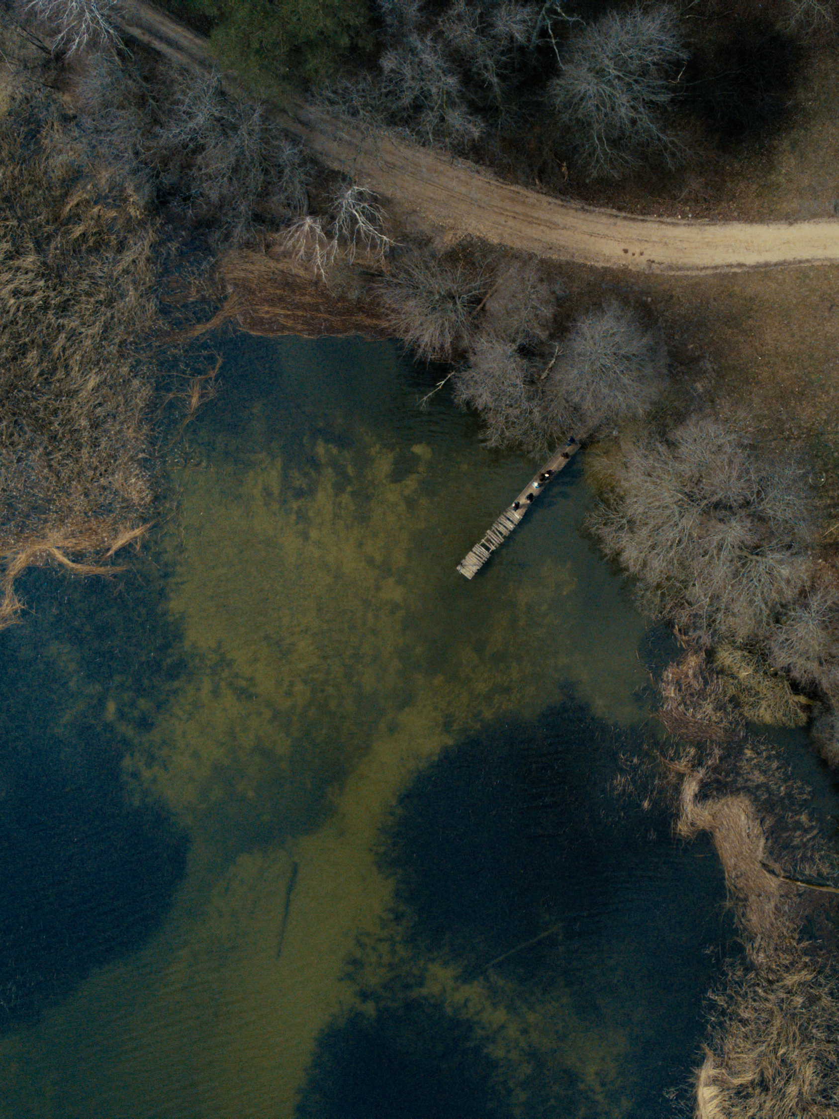 An aerial shot of a secluded lake in the Mazury region of Poland